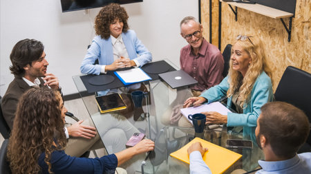 Happy businesswoman discussing strategy with colleagues during conference meeting