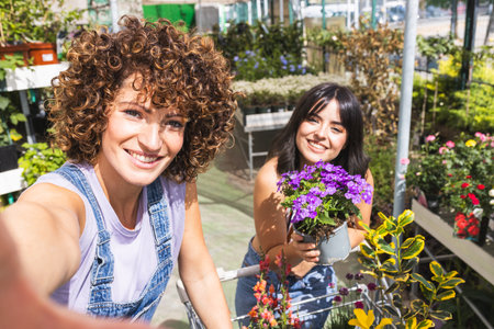 Garden center workers taking a selfie with flowersの写真素材
