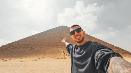Tourist showing the red pyramid of dahshur, egypt
