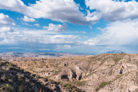 Discovering the majestic badlands of gorafe, spain, under a cloudy skyの写真素材