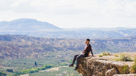 Tourist enjoying the scenic view from a cliff in gorafe, spainの写真素材