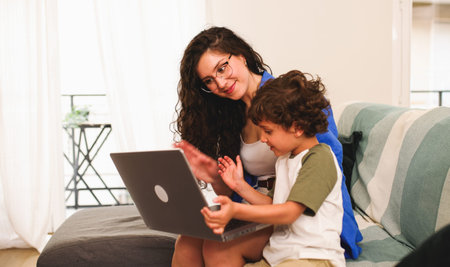 Mother and son making a video call on laptop at home