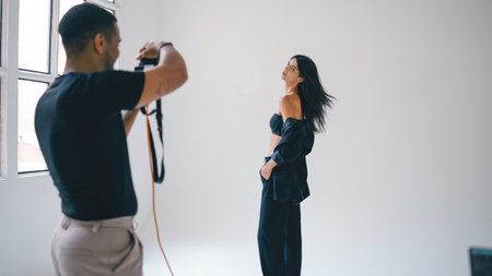 Photographer taking pictures of fashion model in studioの写真素材