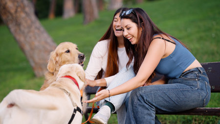 Women and dogs enjoying friendship in a park