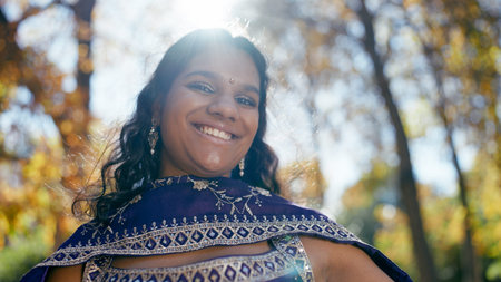 Smiling indian woman wearing traditional sari outdoorsの写真素材