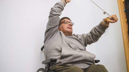 Man in wheelchair exercising during physical therapy