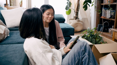 Asian women using smartphone moving into new home