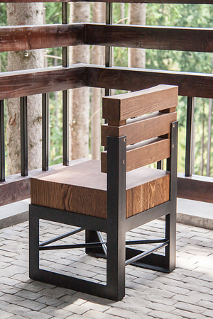 Wooden chair with metal frame on the verandaの写真素材