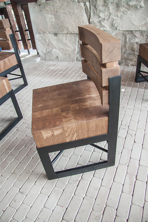 Wooden chair with metal frame on the verandaの写真素材