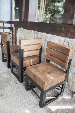 Wooden chair with metal frame on the verandaの写真素材