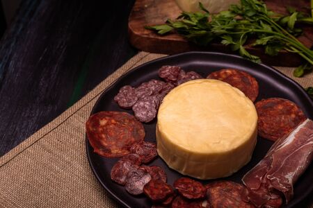 Cheese with serrano ham, olives on a table for a party with friends or as an aperitifの写真素材