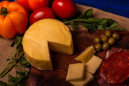 Cheese with serrano ham, olives on a table for a party with friends or as an aperitifの写真素材