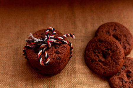 Baked chocolate chip cookies on an artistic background.