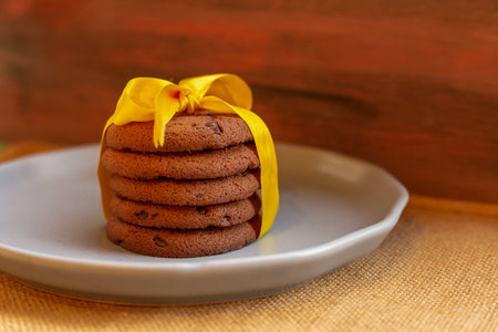 Baked chocolate chip cookies on an artistic background.