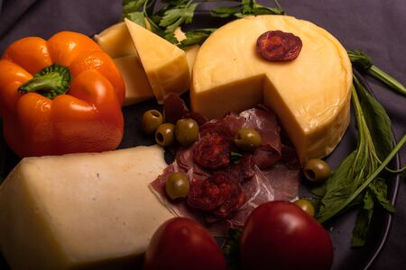 Cheese with serrano ham, olives on a table for a party with friends or as an aperitifの写真素材