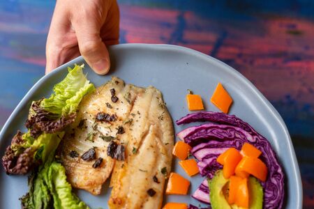 Fish and vegetables on blue tableの写真素材