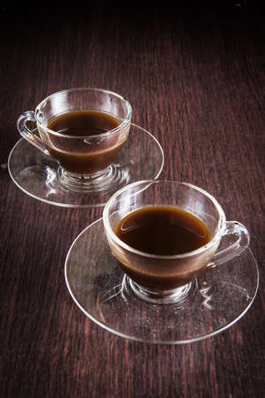 two cup of coffee on the wood floors backgroundの写真素材