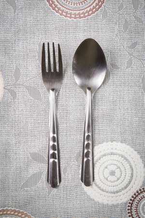 silver fork and spoon on the tableの写真素材