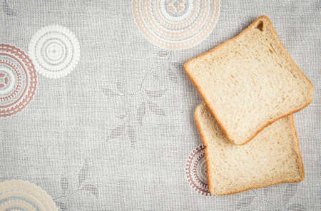 two  bread slice  on the vintage table clothの写真素材