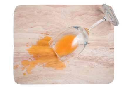 glass of orange juice splash on the wood blockの写真素材