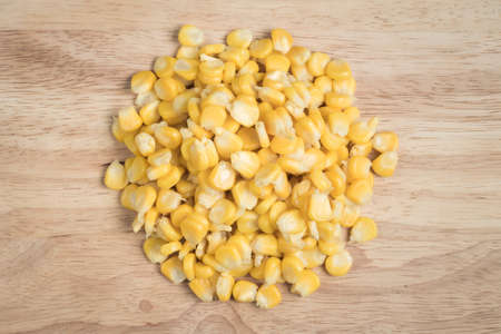 a pile of corn seed on a wood blockの写真素材