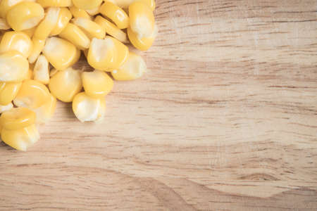 pile of corn seed on a wood block as a backgroundの写真素材