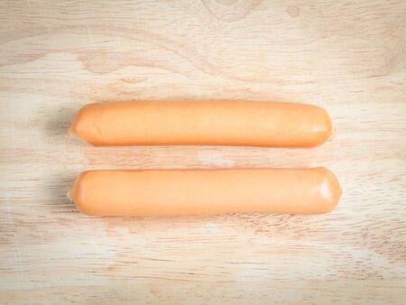 two sausage arrange as equal expression on the wood blockの写真素材