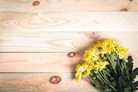 Yellow flower on wooden background with blank space for text.Selective focus.の写真素材