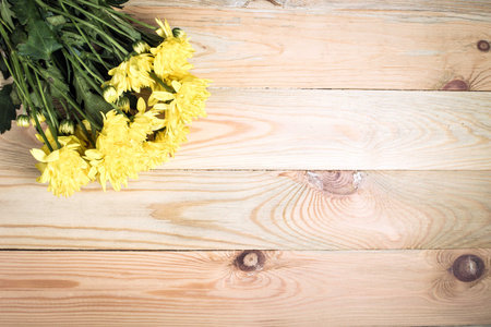 Yellow flower on wooden background with blank space for text.Selective focus.の写真素材