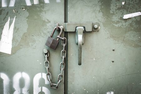 close up  lock  metal door bolt with a  chainの写真素材