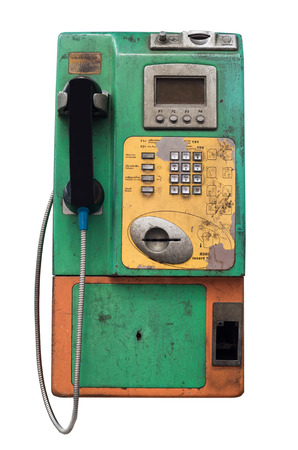 isolated old and dirty  public telephone on the white backgroundの写真素材