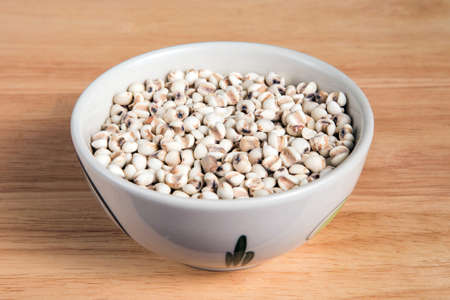 bowl of millet on the wood backgroundの写真素材