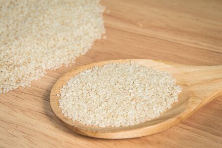 scoop of  sesame in front of a blurry pile of  sesame.Selective focus.の写真素材