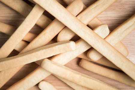 pile of bread stick on a wooden background.の写真素材