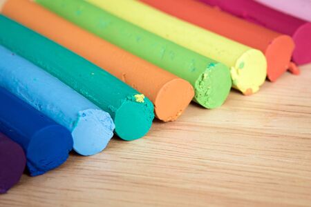 multicolor plasticine bar arrange on a wood backgroundの写真素材