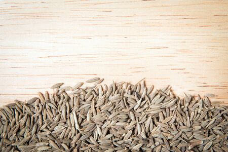 pile of dried cumin and empty space on the wood backgroundの写真素材