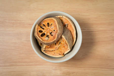 bowl of dried beal fruit on a wood backgroundの写真素材
