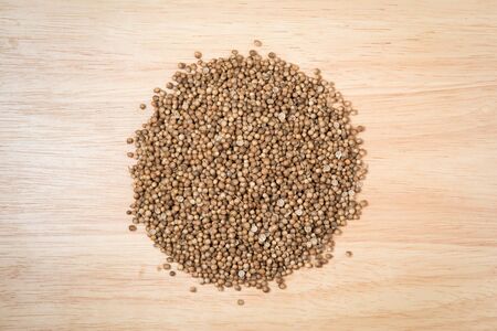 pile of dried coriander seed on a wood backgroundの写真素材