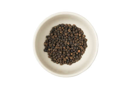 Isolated bowl of black dried pepper on a white backgroundの写真素材