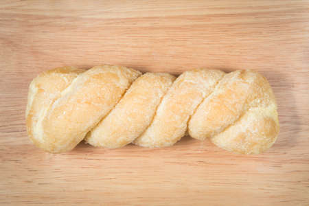 bread knead with sugar and butter on the wood backgroundの写真素材