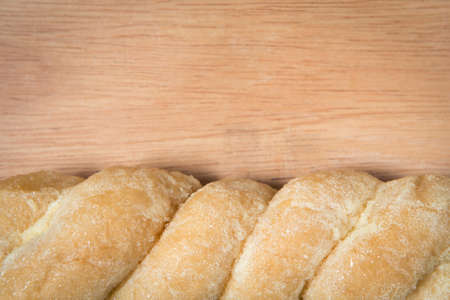 bread knead with sugar and butter on a wood background with empty spaceの写真素材