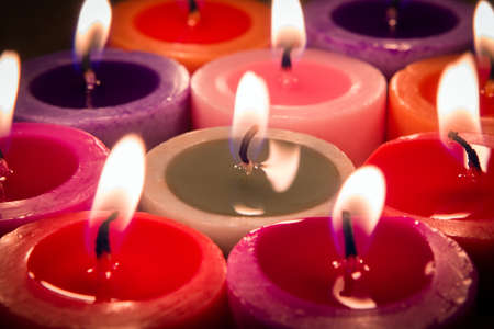 close up multi color flame candle as a backgroundの写真素材