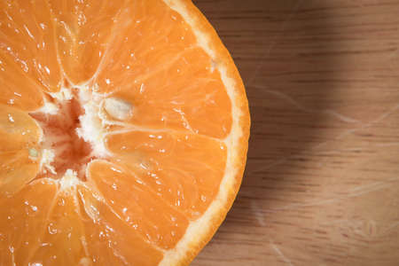 close up slice orange fruit on a wooden blockの写真素材