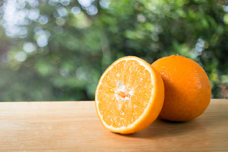 slice orange fruit on a wooden blockの写真素材