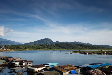 Landscape view of great lagoon in front of a mountain with a village on bottom and a blue skyの写真素材