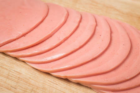 sliced ham arrange on wood backgroundの写真素材