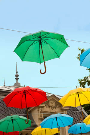 Multi colored umbrellas in blue skyの写真素材