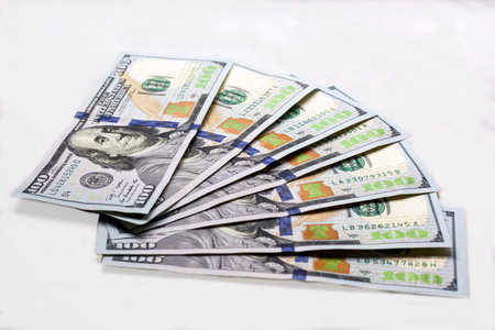 New type hundred dollars banknotes fanned out on white background isolated
