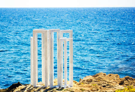 White marble sculpture on rock by sea in Paphos, Cyprusのeditorial素材
