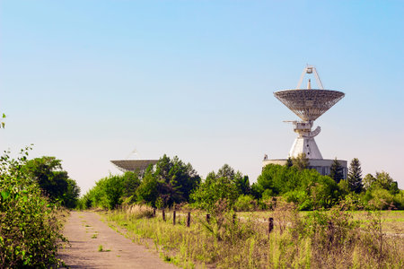Large satellite dish radar antenna station in field. Space Communication Center